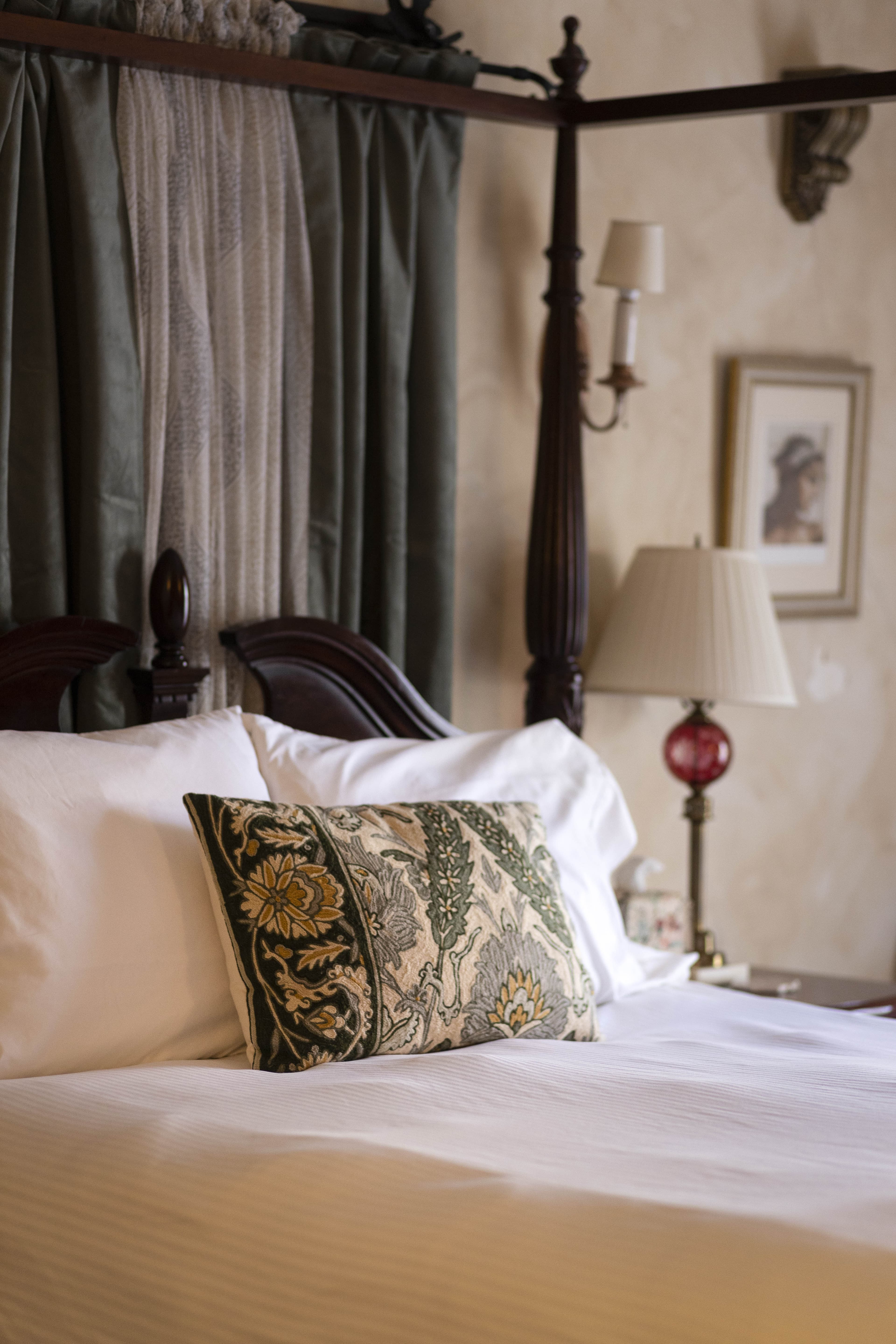 Another angle of the Napoli Guest Room bed showing detailed decor and a cozy atmosphere.