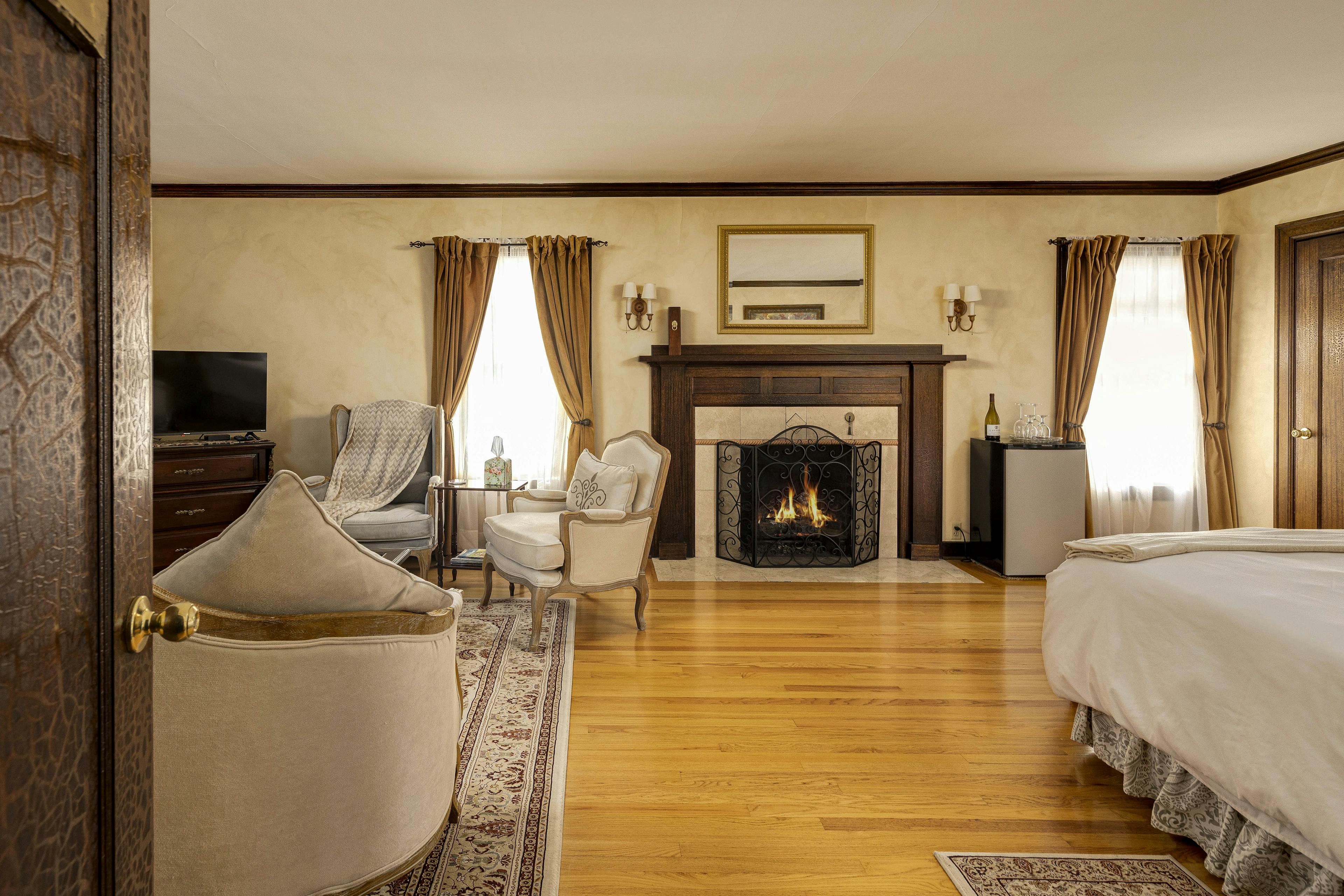 A room with a warm ambiance, a sofa with decorative pillows, a fireplace, and a stylish coffee table.