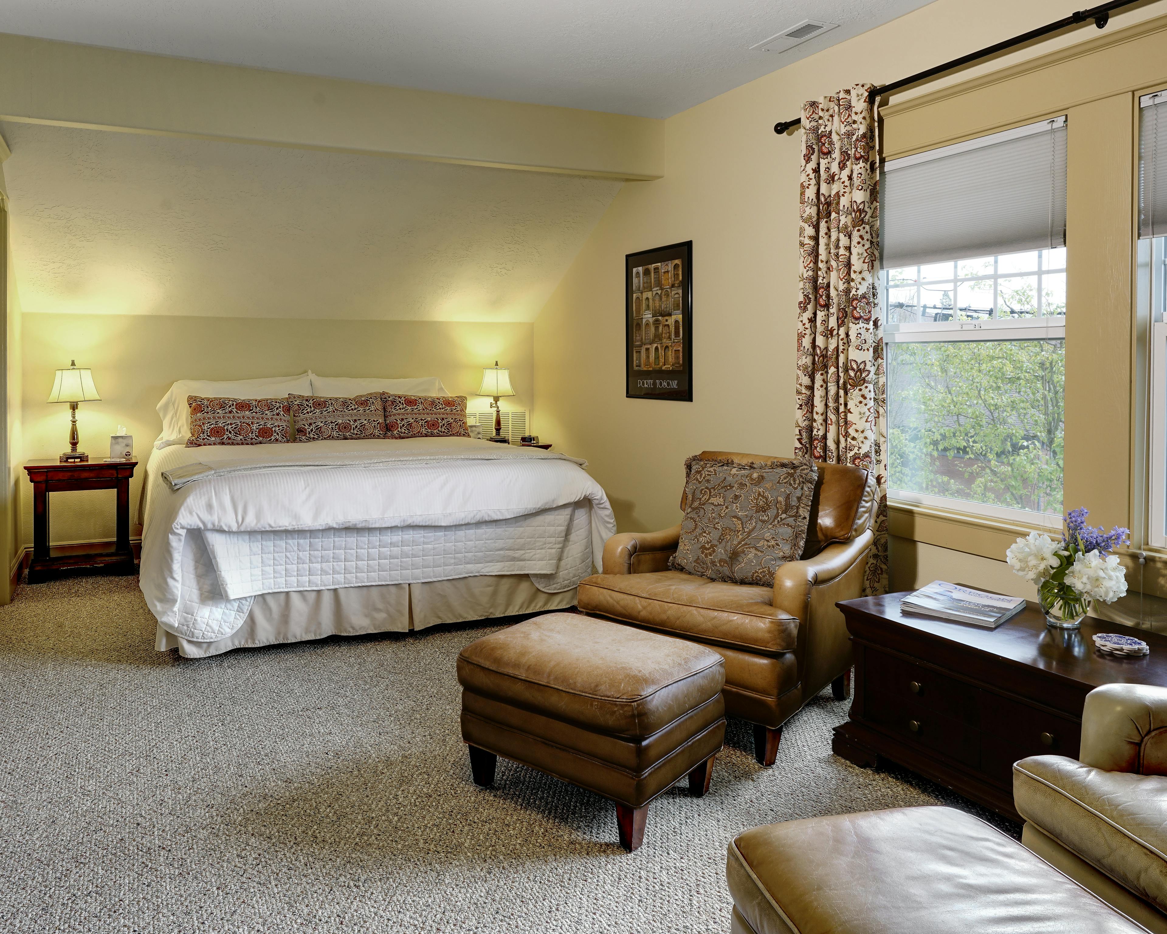 California King bed with leather club chairs in the sitting area.