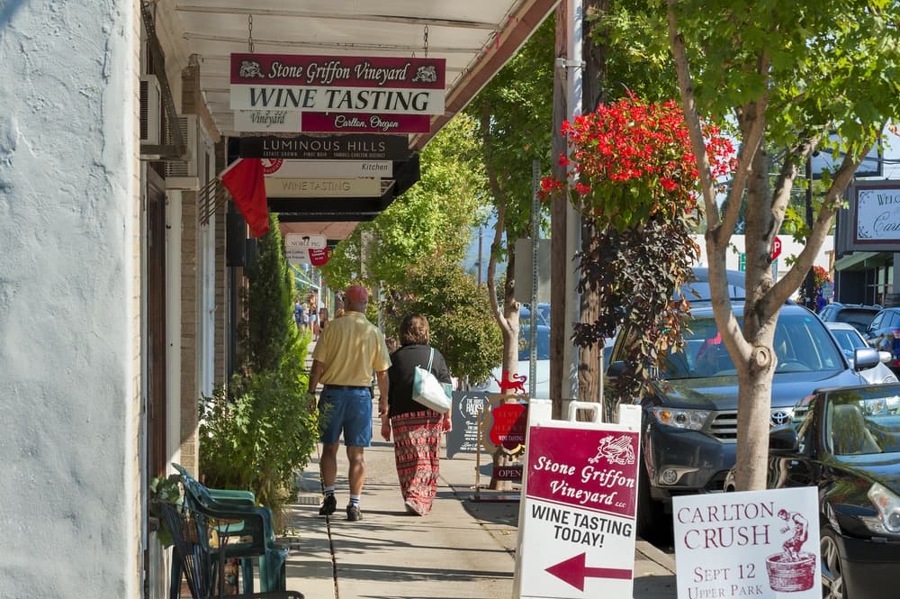 A couple walking through the charming downtown of Carlton, Oregon