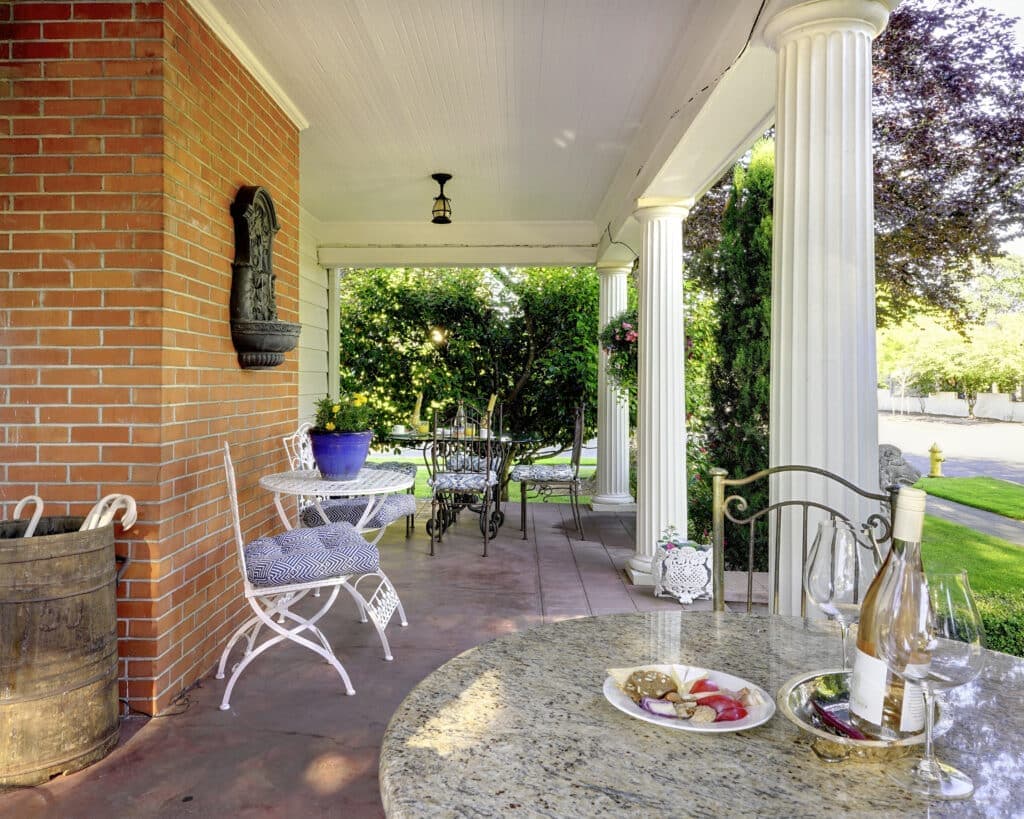 Glass of wine and food on the porch at our McMinnville Bed and Breakfast - this is one of the best things to do in McMinnville