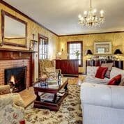 Cozy living room featuring a fireplace, plush seating, and elegant decor.