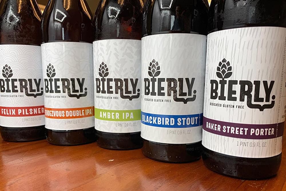 Five bottles of Bierly craft gluten-free beer lined up, each labeled with its beer name and style.