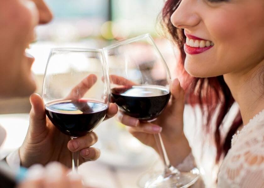a romantic couple toasting wine a romantic couple toasting wine