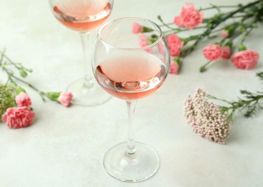 two glasses of wine with a backdrop of spring floral