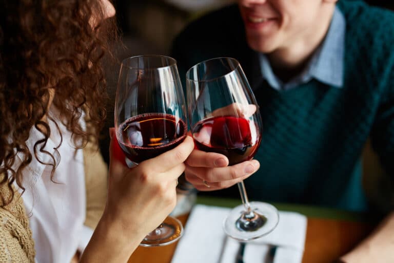 A couple drinking wine while enjoying a meal at the top restaurants in McMinnville