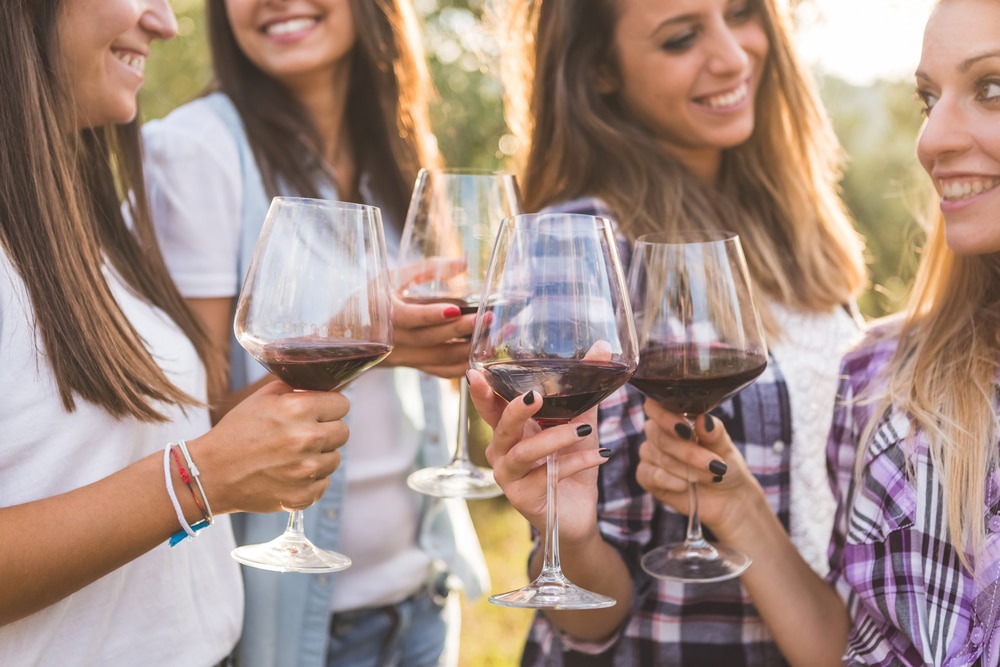 Girlfriends enjoying outdoor wine tasting at the best wineries in Oregon